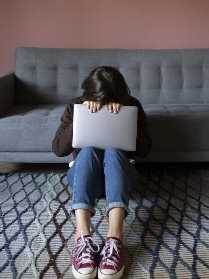 full-shot-anxious-woman-holding-laptop